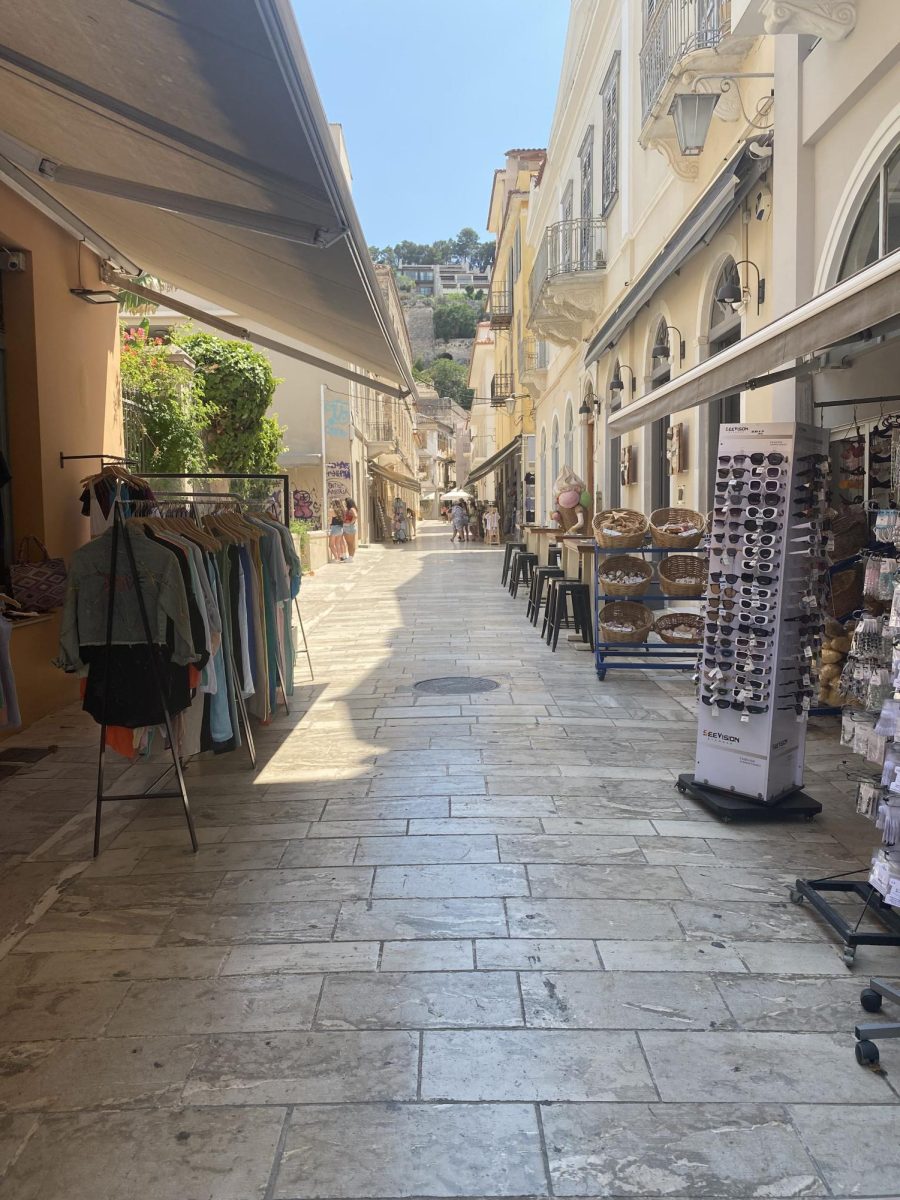 A beautiful cobblestone street lined with boutique shops and cafes, in Nafplio, Greece